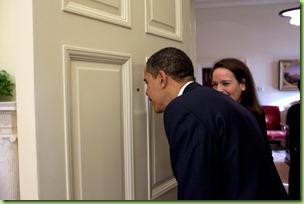 President Barack Obama looks through the Oval Office door peephole as his personal secretary Katie Johnson  watches 3/12/09.
Official White House Photo by Pete Souza