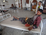 I was told that this guy was taken by government forces and tortured for six months, and that he was recently released and can no longer walk. From the thick callus on the outide of his foot and his well-developed upper body, my guess is that  he has had the handicap all his life. I'm skeptical about his story, but at leat he is taken good care of regardless how he ended up here.