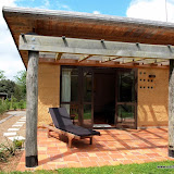 Private patio to lounge on overlooking organic gardens at the Cob Cottage.