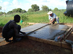 Screeding concrete base for rainwater tank