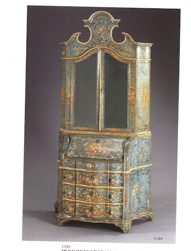 A bureau-cabinet painted pale blue and white and heavily decorated. Some hidden details: it has mirrored doors and a bombe case that opens up to reveal secret drawers. A bureau-cabinet painted pale blue and white and heavily decorated. Some hidden details: it has mirrored doors and a bombe case that opens up to reveal secret drawers.