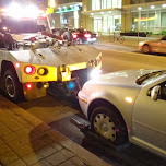 car getting towed on spadina in toronto in Toronto, Canada 