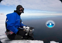 Photographer Paul Nicklen sitting on the edge of an ice floe. Photographer Paul Nicklen sitting on the edge of an ice floe.
