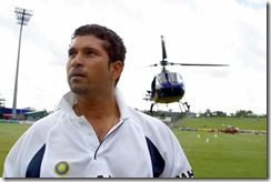 Tendulkar inspects the condition of the ground as a helicopter hovers in the background to dry the field