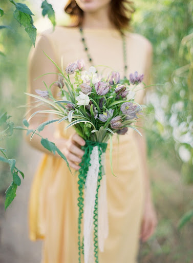Kate mixed the fritillaria with sword fern and variegated wild grass blades. Layers of vintage trim lent the bundle a bit of romance.