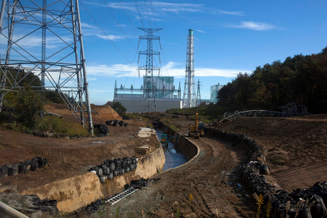 Units five and six of the Fukushima Dai-ichi nuclear power station are seen through a bus window in Futaba, Japan Saturday, 12 November 2011. David Guttenfelder / AP