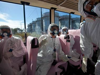 Reporters ride a bus into the radiation zone of the Fukushima Daiichi nuclear plant, 13 November 2011. They wear protective suits, double gloves, double layers of clear plastic booties over shoes, hair covers, respirator masks, and they carry radiation detectors. independent.co.uk