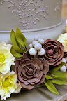 Ana placed the flowers on the bottom tiers of the cake.