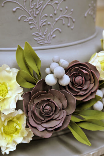Ana placed the flowers on the bottom tiers of the cake.