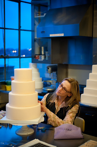 Here, Wendy is in one of the test kitchens piping cakes. This was one of the stops on the tour of our office.