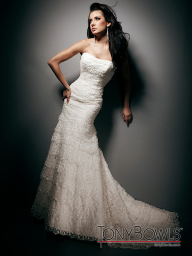 The layered lace on this Tony Bowls gown creates soft, elegant lines. The layered lace on this Tony Bowls gown creates soft, elegant lines.