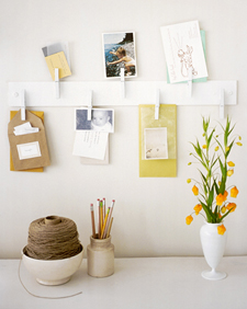 Mounted at eye level above a desk, clothespins on an unobtrusive strip hold home-office essentials: correspondence, a calendar, and whatever is relevant at the moment.