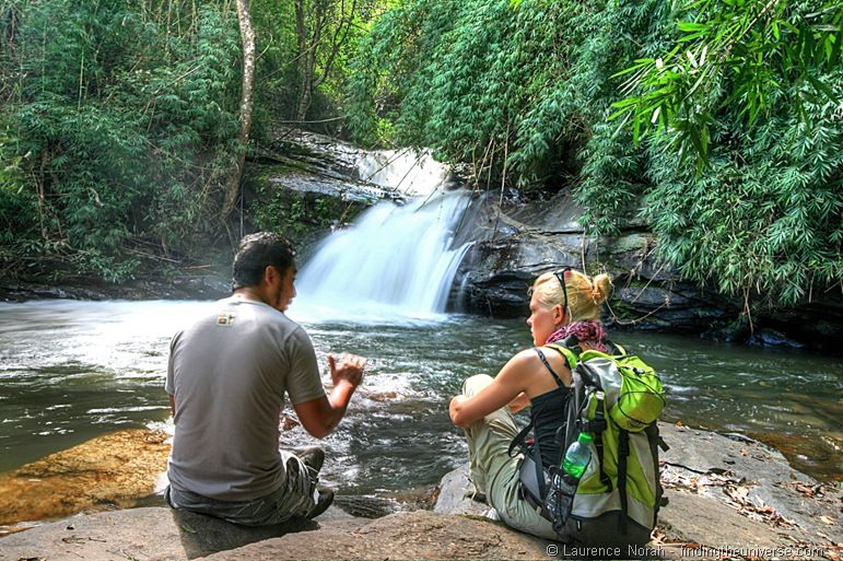 Vera talks in front of waterfall