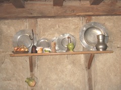 Plimoth Plant pewter plates on shelf Plimoth Plant pewter plates on shelf