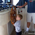 Matthew driving the houseboat in the main channel, towing the ski boat.