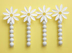 Tubes of gum balls accented with the paper daisy flower makes a great favor. Tubes and paper daisies sold separately.