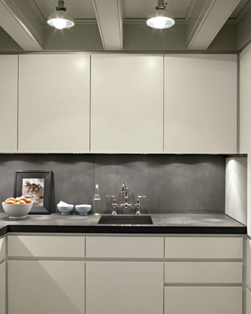 Space in the kitchen is tight, and Eric wanted to keep the counters as clear as possible. Cabinets, therefore, were designed to conceal appliances while keeping them handy; electrical outlets are hidden under the upper cabinets. Space in the kitchen is tight, and Eric wanted to keep the counters as clear as possible. Cabinets, therefore, were designed to conceal appliances while keeping them handy; electrical outlets are hidden under the upper cabinets.