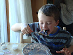 Daniel scarfs down leftover pancakes that Camille shared with him.