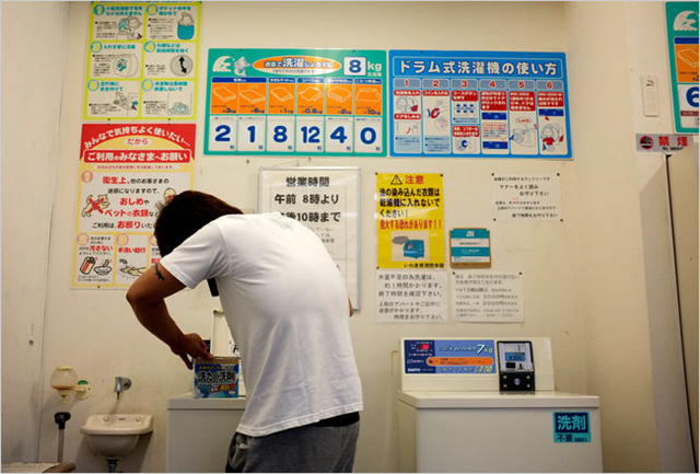 A construction worker at the Fukushima Daiichi nuclear plant does his laundry in Iwaki-Yumoto, which has become a hub for migrant labor. Kosuke Okahara for The New York Times