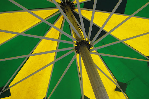 Bright and cheerful umbrellas shield each of the dining tables from sun...or rain.