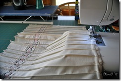 Stitching pleats down at the top.