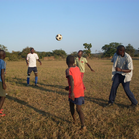 Football is very popular in Zambia and all across Africa. These people are fortunate to be useing a 'proper' football.