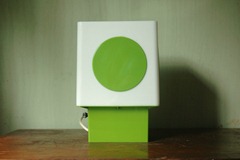white lamp with green base and green dot