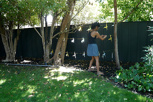 Jen's friend Joanne tests the bird garland.