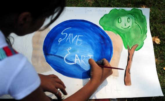 An Indian child paints during an awareness event organized by the Aakalpan Artist Society commemorating Earth Day in Allahabad. Photo: Sanjay Kanojia / AFP / Getty Images