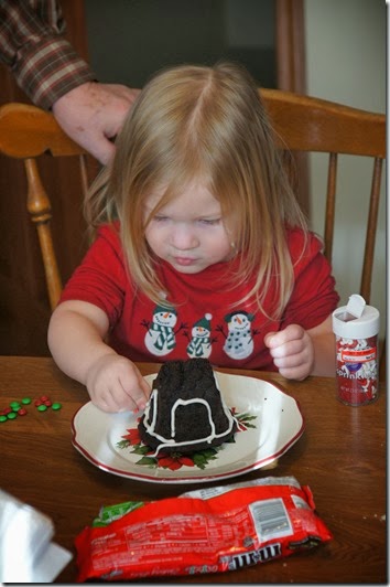 toddler decorating her gingerbread house toddler decorating her gingerbread house