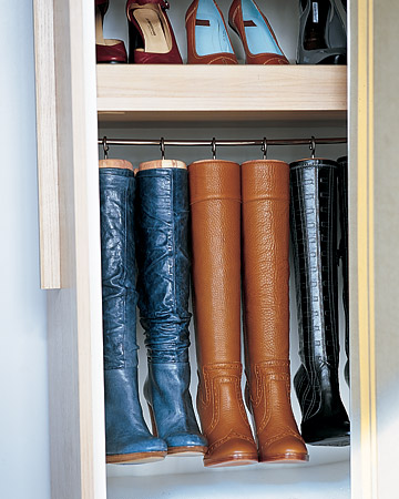 Homemade hangers preserve the shape of tall boots and maximize space. They're created by replacing the knobs on cedar boot trees with large cup hooks, which are screwed into the tops. The trees and boots then hang from a cafe-curtain rod. Homemade hangers preserve the shape of tall boots and maximize space. They're created by replacing the knobs on cedar boot trees with large cup hooks, which are screwed into the tops. The trees and boots then hang from a cafe-curtain rod.