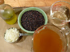 Olive oil, onion, rice, white wine, and roasted vegetable broth at the ready