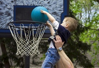 4873663-adult-helping-boy-score-a-basketball-shot