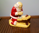 Kneeling_Santa_with_Baby_Jesus_by_Rudolph_Vargas_commissioned_by_Raymond_P_Gauer
