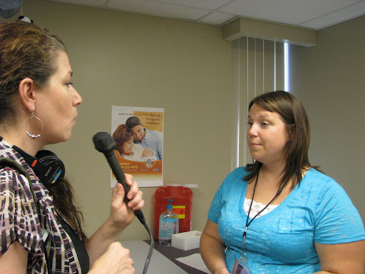 KSMU's Theresa Bettmann talking with Ruth Brown, public health nurse, about the importance of vaccinations. Photo credit: Marrie Yvonne Ochieng