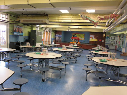 The cafeteria is designed to inspire good manners and appreciation of food, with flowers on the tables and real glasses, plates, and silverware in use.