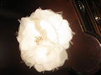 Here's a fabric flower by Sara Gabriel. The bloom's sparkly center has a glamorous feeling that is a great option if you're looking for an extra special touch at your wedding. If you're getting married where it's humid, you might want to consider a faux flower for longevity.