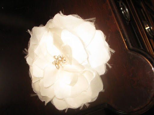 Here's a fabric flower by Sara Gabriel. The bloom's sparkly center has a glamorous feeling that is a great option if you're looking for an extra special touch at your wedding. If you're getting married where it's humid, you might want to consider a faux flower for longevity.