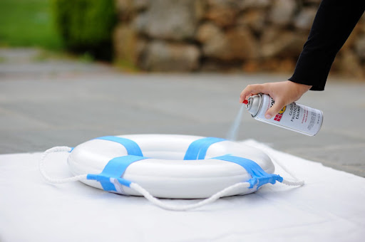 Steps 2 and 3: Place the preserver on a drop cloth in a ventilated area. Put on your safety mask, and spray one side of the float. Let it dry for 10 to 12 hours. Then, flip it over and repeat on the opposite side. Once it's dry, use a stencil brush to stipple on your Steps 2 and 3: Place the preserver on a drop cloth in a ventilated area. Put on your safety mask, and spray one side of the float. Let it dry for 10 to 12 hours. Then, flip it over and repeat on the opposite side. Once it's dry, use a stencil brush to stipple on your