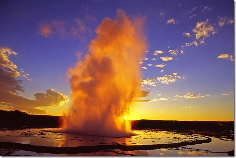 Great Fountain Geyser in Yellowstone National Park is lit by the sun, giving it an orange glow. (photo ©Leon Jenson — click to enlarge) 
