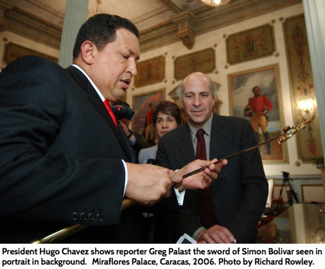 President Hugo Ch&agrave;vez shows reporter Greg Palast the sword of Sim&oacute;n Bolivar, seen in portrait in background, Miraflores Palace, Caracas, 2006. Photo: Richard Rowley