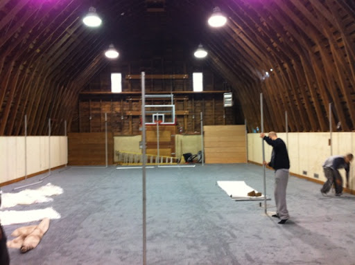 Once the carpet was laid, pipes were put up so fabric could be draped along the perimeter.