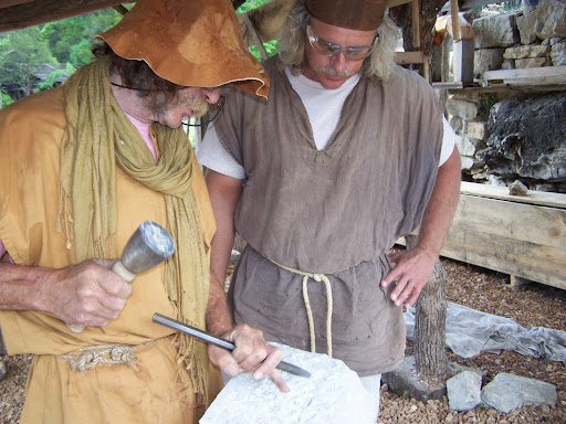 Franck Falgairette shows Keith Barnhart how to make a stone flat using a primitive chisel.