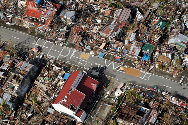 An aerial view shows signs for help and food amid the destruction left from Typhoon Haiyan in the coastal town of Tanawan, central Philippines, Wednesday, 13 November 2013. Typhoon Haiyan, one of the strongest storms on record, slammed into six central Philippine islands on Friday leaving a wide swath of destruction and thousands of people dead. Photo: Wally Santana / AP