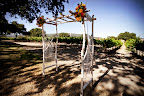 The ceremony structure framed the couple and the vineyard background. The ceremony structure framed the couple and the vineyard background.