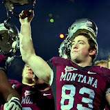 Brody McKnight celebrates as fireworks go off in the background.
