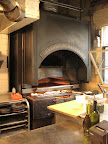 This open-fire oven is visible from the dining area of the restaurant.