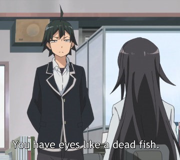 Hachiman stands at attention facing the viewer, eyes narrowing in annoyance, as his teacher sits in front of him with her back to the viewer, saying "You have eyes like a dead fish."