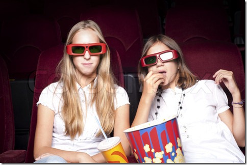 two beautiful girls watching a movie at the cinema