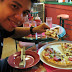 Hubby taking a slice of Sicilian Pizza from Papa Razzi's
